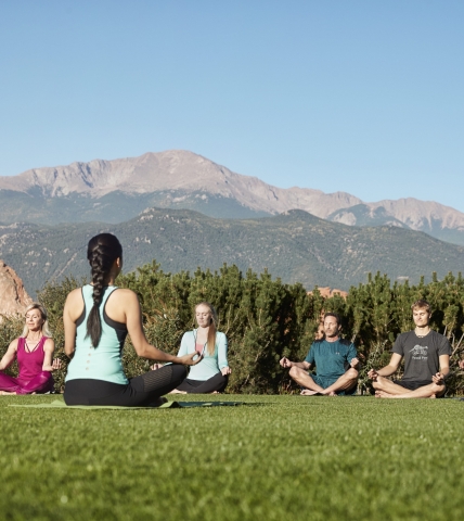 A group doing yoga outdoors at Garden of the Gods Club Resort