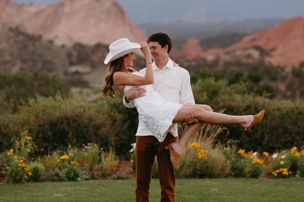 Hailey and Chris wedding portrait in front of Colorado Springs red rocks at a scenic destination wedding venue.