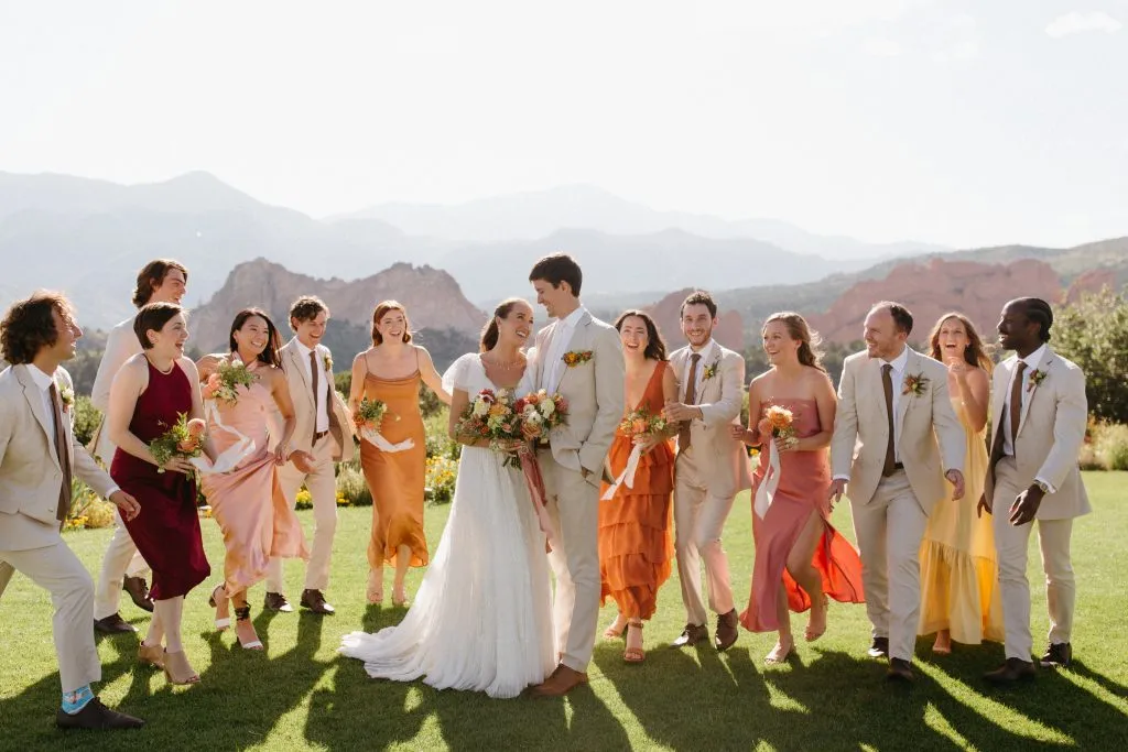 Destination wedding party walking across the lawn at Garden of the Gods Resort in Colorado Springs.