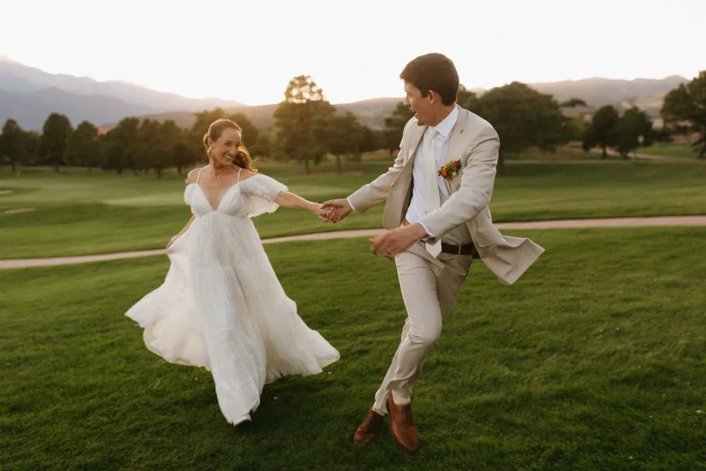 Newlyweds dancing on the lawn during a luxury Colorado Springs destination wedding celebration.