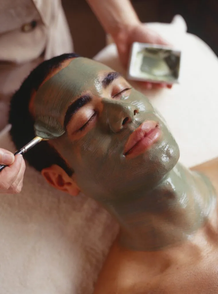 a young man having a mud mask facial at garden of the gods resort and club in colorado springs